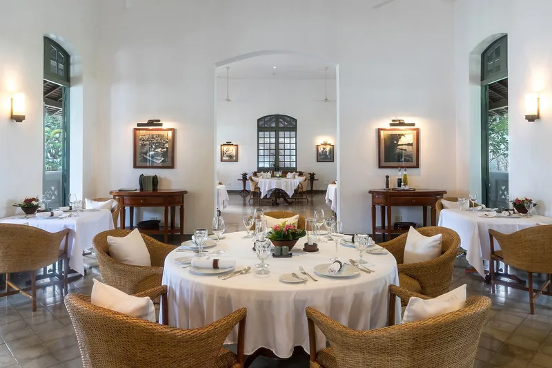 Elegant restaurant dining room laid out with polished tables and chairs