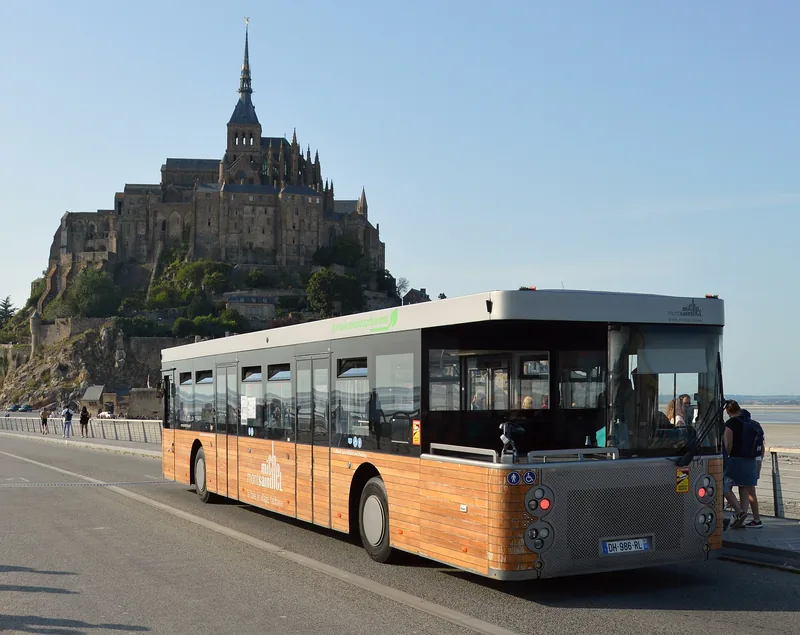 Shuttle bus carrying passengers across a bridge to a visitor site